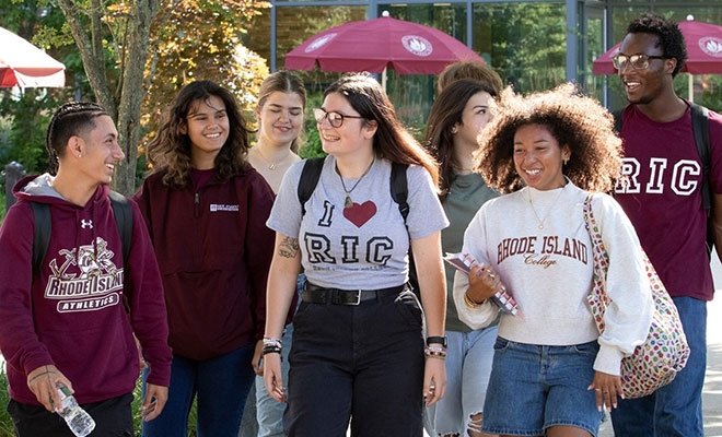 Students in RIC gear walking in sunshine on campus
