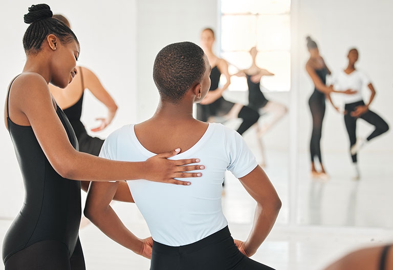Dance instructor teaching student in class