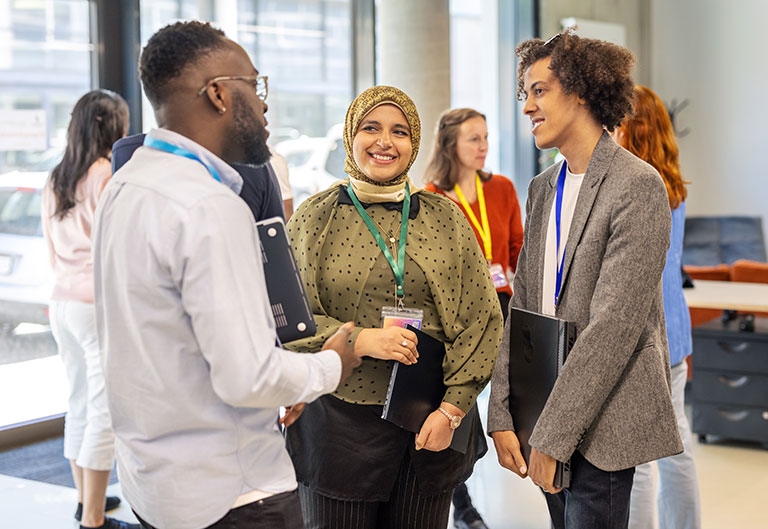 Diverse professionals standing and talking in office setting