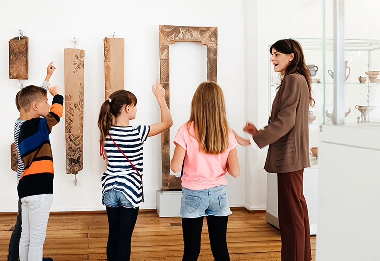 Historian speaking to young children in a museum