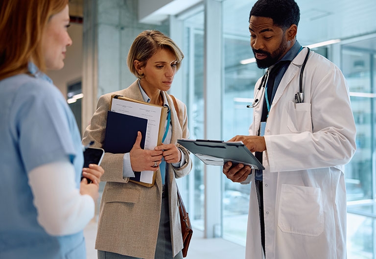 Hospital administrator talking to doctor and nurse