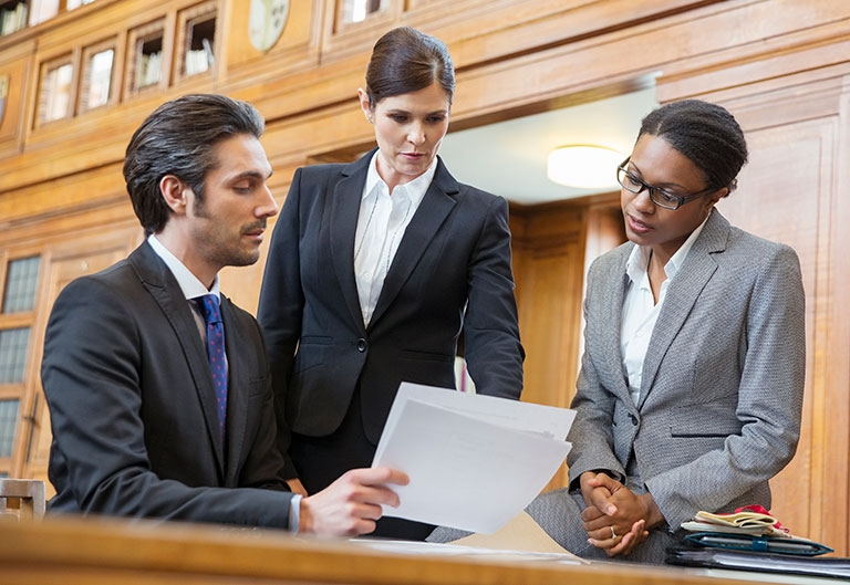 Lawyers examining documents in court
