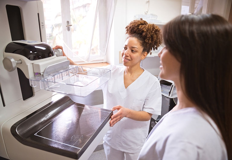 Mammography technologist with patient