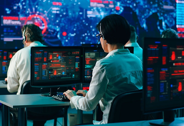 People writing security code on computers during global digital virus attack