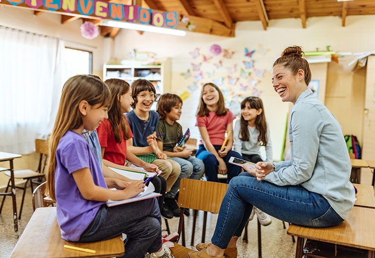 Spanish teacher laughing in class with students