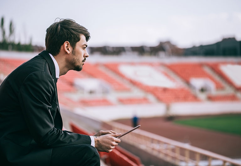 Sports business manager working in stadium stands