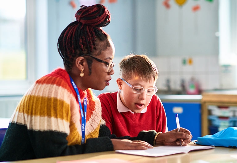 Teacher working with student with down syndrome