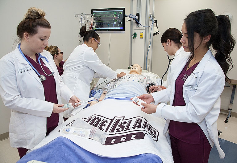 Students working on mannequin in nursing simulation