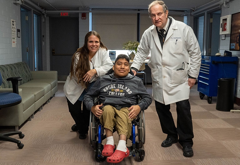 Health Services director and doctor with student in wheelchair