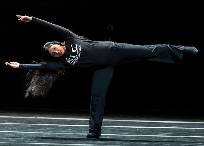 Dance major, Andreina Mendoza stretching her legs in a 90 degree angle