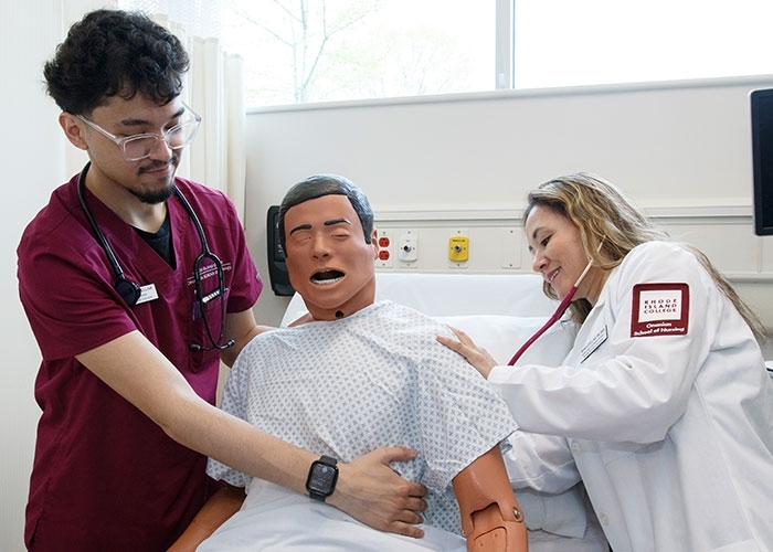Mirna and Gabriel Cuellar working on medical dummy in nursing simulation
