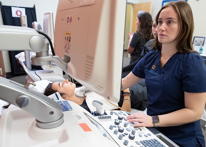 Medical Imaging student monitoring patient using equipment