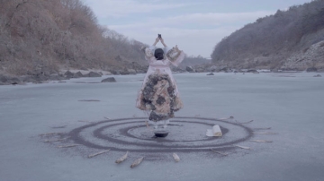 Woman standing surrounded by ripples