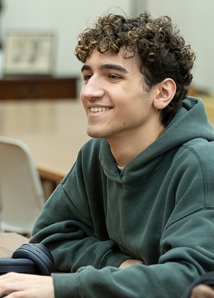 Boy smiling at table in class