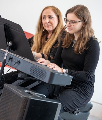 Judith Stillman at keyboard with student