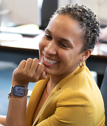 Student smiling in RIC's Finance Lab