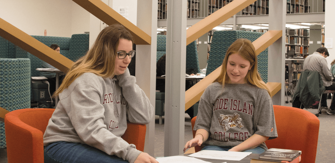 students looking at books photo