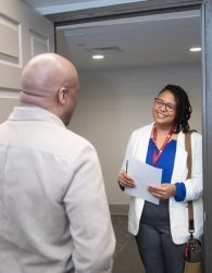 Vilna Tejeda, Assistant Professor of Social Work greeting someone