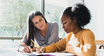 Counselor helping a student at a table
