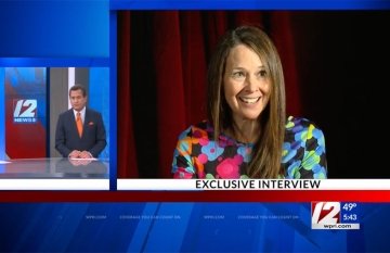Jen Easterly being interviewed on news channel 12