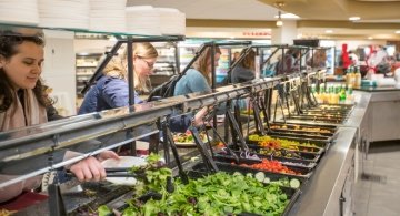 Students serving themselves at salad bar
