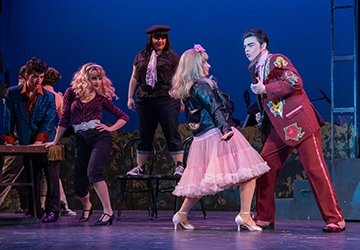 Theatre students on stage in production of Grease