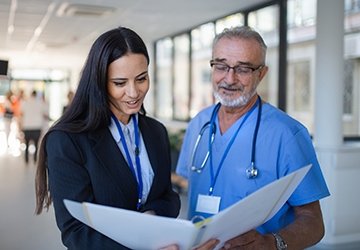 Doctor and administrator looking at patient chart