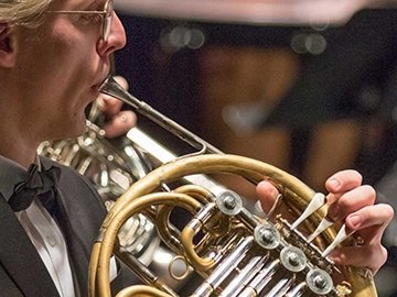 Symphony orchestra french horn player