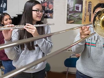 Younger students playing band instruments
