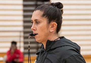 Jenna Cosgrove, RIC women's basketball coach, with whistle in mouth