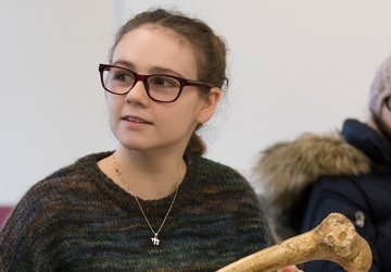 Student examining bones in anthropology class