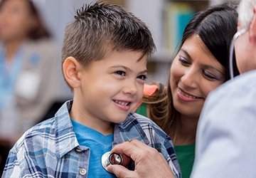 Young boy being checked by a doctor in the community