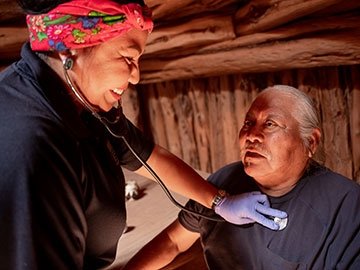 Nurse listening to patient breathing via a stethoscope