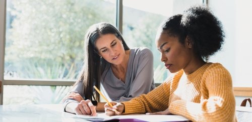 Counselor helping a student at a table