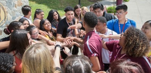 Students in a huddle during orientation