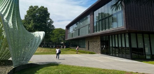 Campus grounds outside Alexi and Ani building, with nearby sculpture