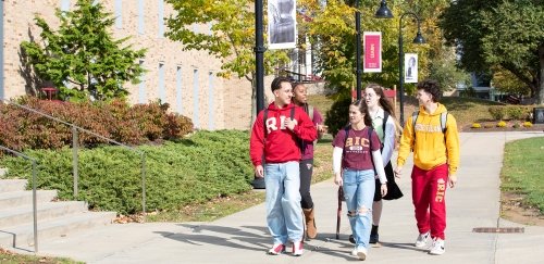Students in RIC gear walking on the quad in fall