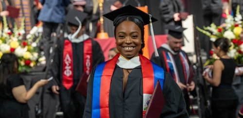 Smiling graduate holding diploma