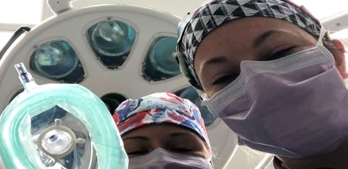 Two anesthesia nurses standing over a patient