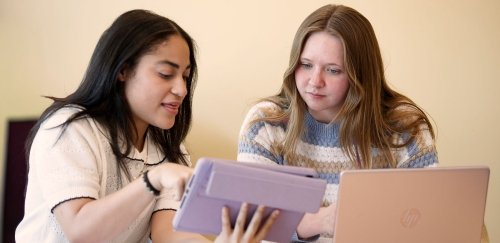 Students working together over a laptop and tablet