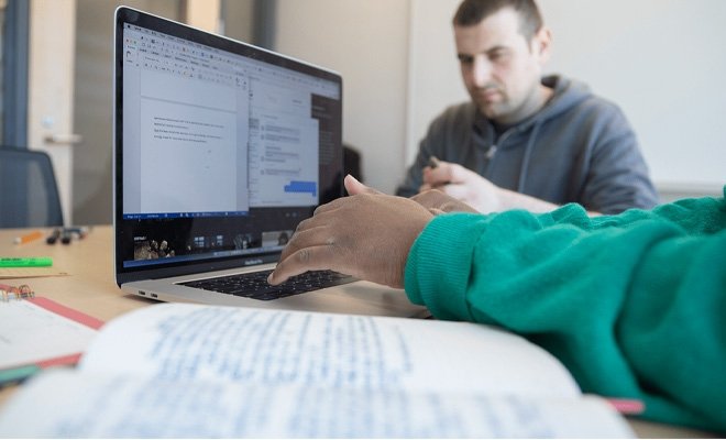 RIC students working at a laptop