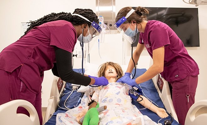 RINEC nursing students working on medical dummy