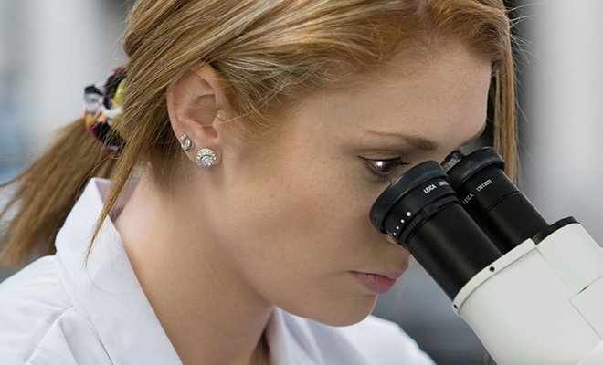 Biology student looking in microscope