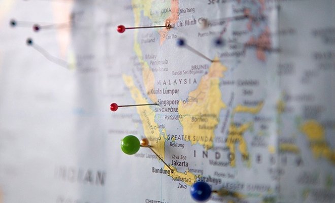 Map with pushpins stuck into it on various locations