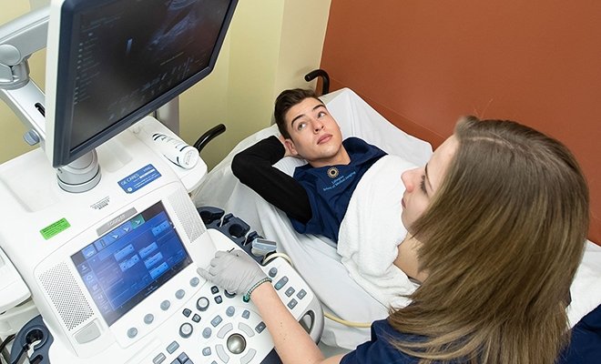 Medical Imaging student working with patient