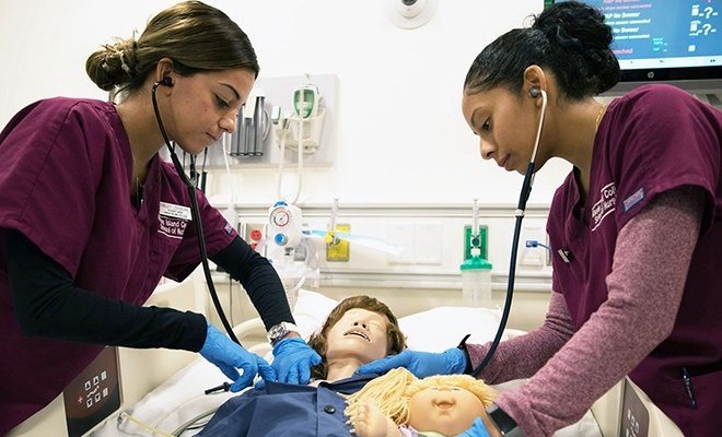 Nursing students working on medical dummy at the Rhode Island Nursing Education Center