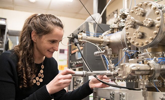 Physical science professor working on machinery