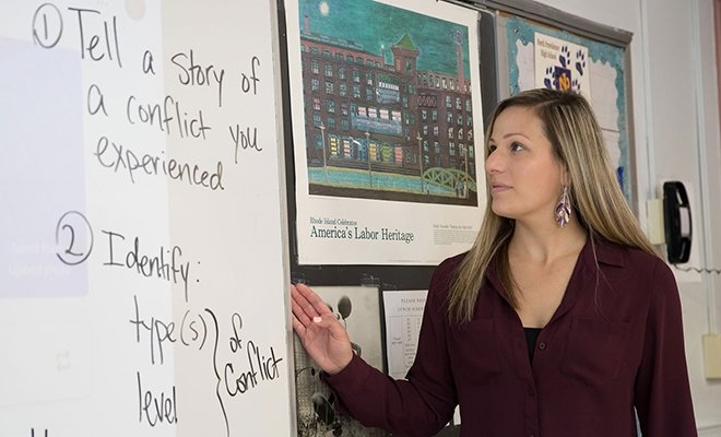 Professor teaching at white board