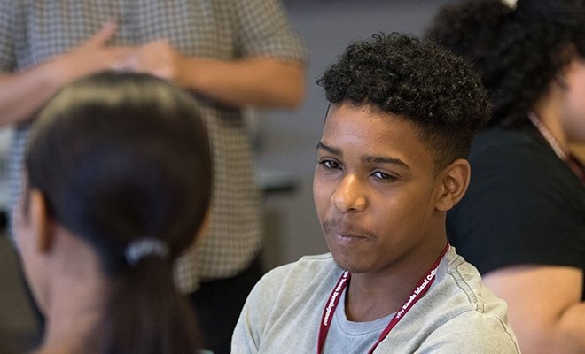 Student in a group, smiling