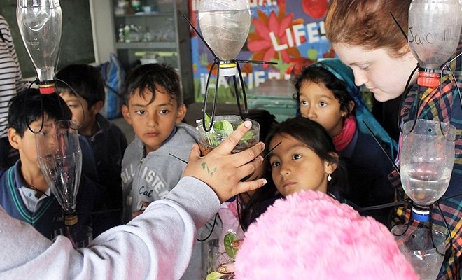 Students working on hydroponics with children